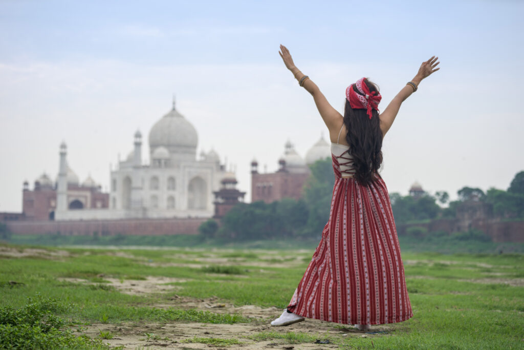 Woman posing in front of the Taj Mahal during a 2-day Agra and Fatehpur Sikri tour