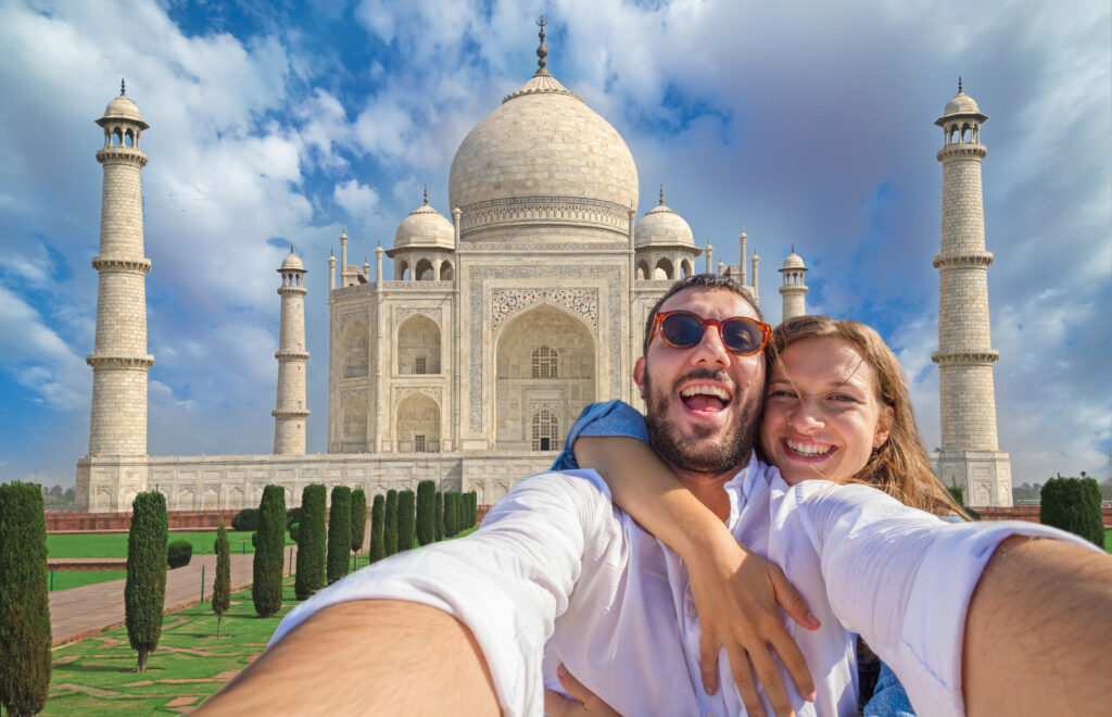Couple taking a selfie in front of the Taj Mahal during a private Agra tour